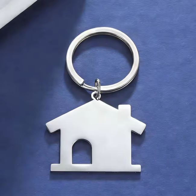 Silberfarbener Schlüsselanhänger in Hausform mit Türausschnitt
